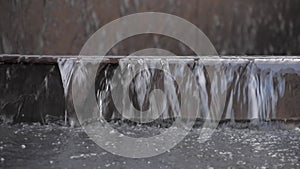 Close-up of water flowing down the stairs. Flooding in the city. Uncontrolled water on the streets.