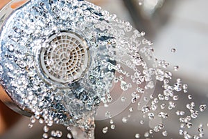 Close up water flowing out from sink shower in kitchen
