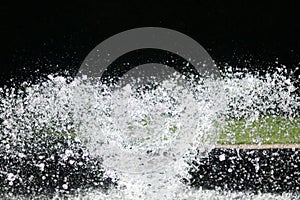 Close up of water fountain in garden with grass in background