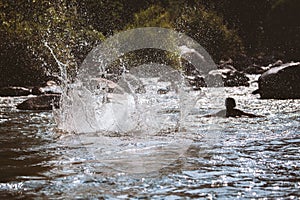 Close-up of water huge splashing in pond from people falling into water