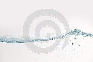 Close up water splash with air bubbles. Fresh and clean surface aqua flowing in wave and clean water on white background isolated