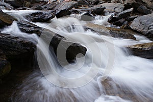 Close up water from waterfall flow pass stone, Thailand waterfall