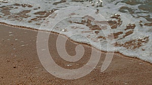Close up of water wave on sandy beach, a beautiful Aeolian landform
