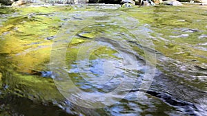 Close-up of a waterfall stream. wild mountain river abundant clear stream. Waterfall with crystal clear waters, agitated waters