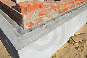 Close-up of the waterproofing of the brick wall from the foundation of the new house construction