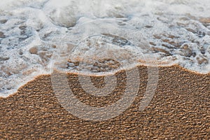 Close-up of a wave hitting a beach