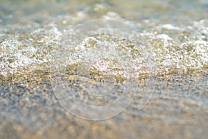 Close up of a wave rolling onto the beach