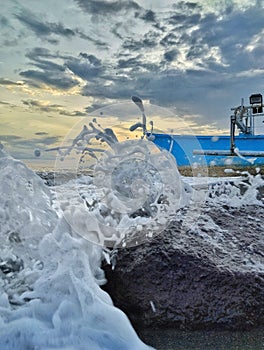 Close up of waves and boats on the beach