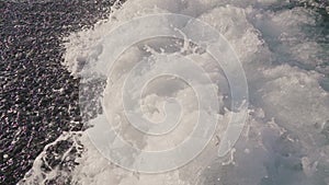 Close up of waves crashing on an empty beach