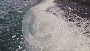 Close up of waves crashing on an empty beach