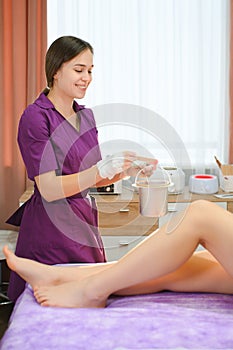 Close up waxing in by a beautician in a spa center