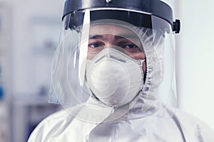 Close up of wearied chemist in laboratory wearing ppe equipment photo