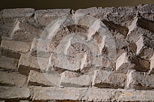 Close-up of weathered, aged brick structure with a zigzag pattern photo