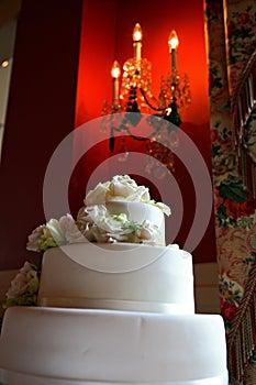 Close up of wedding cake with red wall