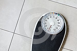 Close-up Weighing Scale in bathroom on stone ground.