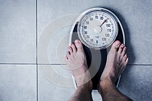 Close-up Weighing Scale ,Men standing on weigh scales.