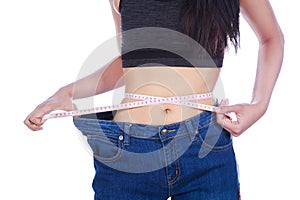 Close up weight loss woman wearing her old jeans and measure tap