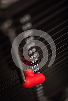 Close up of a weight stack on gym apparatus