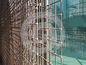 Close up of welded wire mesh with glass background, copyspace