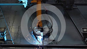 Close-up of welding of metal parts by welding machine at factory. Scene. Large industrial robots-welders of metal auto