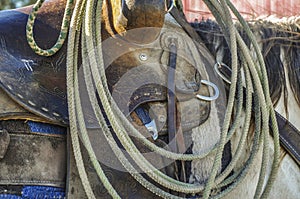 Close up of a western saddle with a rope for cattle.