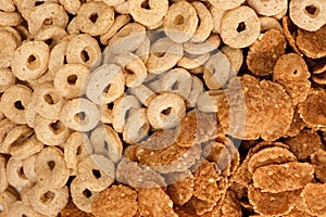 Close-up of wheat flakes and corn rings, top view.