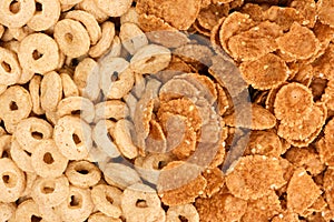 Close-up of wheat flakes and corn rings, top view.