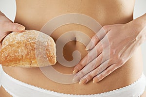 Close Up Of Wheat Intolerant Woman Holding Bread