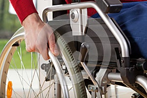 Close-up on wheelchair of capable disabled