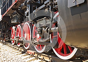 Close-up of the wheels of an old steam locomotive