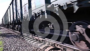 Close up of wheels of train going by railway