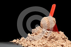Close-up Whey Protein Powder in measuring scoop.