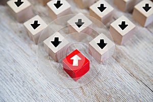 Close-up white arrow icon on cube wooden toy block stacked with pointing to opposite directions for way of adapting to change