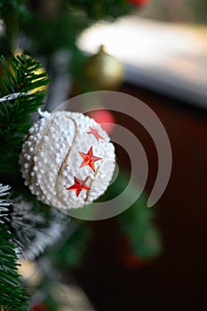 Close-up of the white ball hanging from the Christmas tree