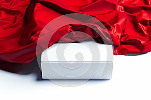 Close up of white blank box under red cloth on white background. 3d rendering.