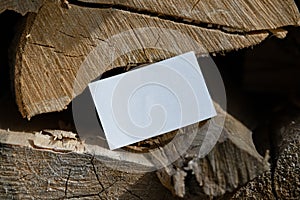 Close up Of White Blank Business Card With Empty Space on Firewood Background. Corporate Branding. Copy Space