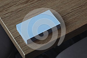 Close up of white blank illuminated by daylight business cards set on wooden table, 3d rendering.