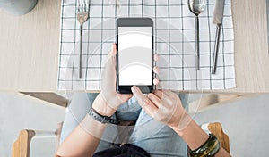 Close up white blank screen mobile over restaurant table order food online