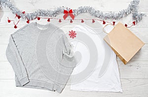 Close up white blank template t shirt, sweatshirt hoodie with copy space. Christmas Holiday concept. Top view mockup paper bag