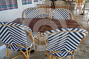 close up white and blue rattan chairs with dining table in restaurant