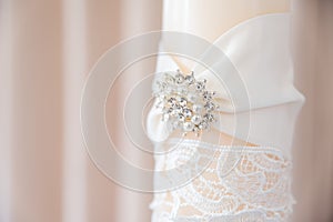 Close Up of White Candle with Diamond and Pearl Broach