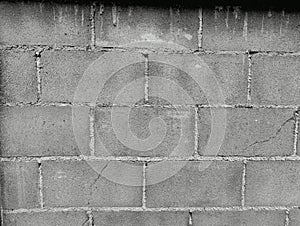 Close-up of White cement crack block wall and peeled paint caused by water and sunlight. Peel wall of White house paint with black