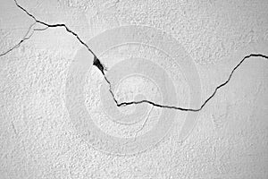 Close-up of White cement crack wall and peeled paint caused by water and sunlight. Peel wall of White house paint with black stain
