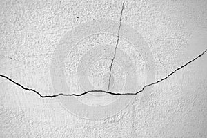 Close-up of White cement crack wall and peeled paint caused by water and sunlight. Peel wall of White house paint with black stain