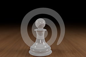 White, glass, chess pawn on a hard wood surface