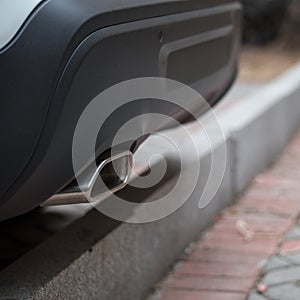 Close-up of a white Citroen C5 aircross plastic rear bumper and exhaust pipe