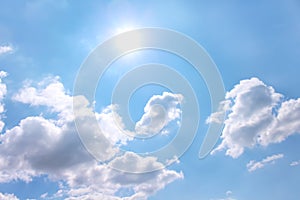 White clouds patterns with sun on bright blue sky background