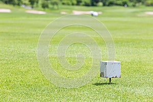 Close-up white color wooden tee off area or tee box with blurred