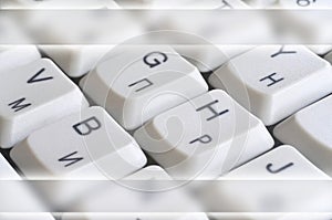 Close-up of the white computer classic keyboard with english and russian letters with copy space fiel