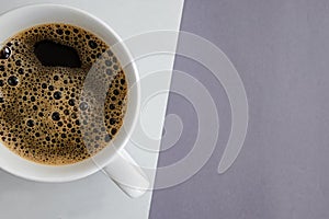 Close-up of white cup with fresh hot black coffee